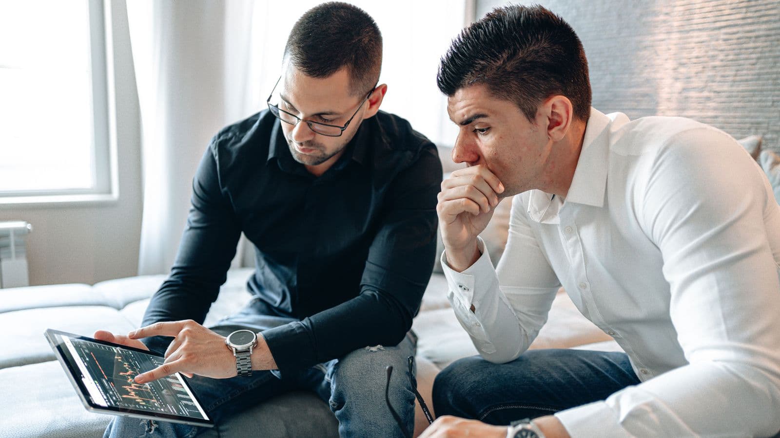 Men reviewing stock info