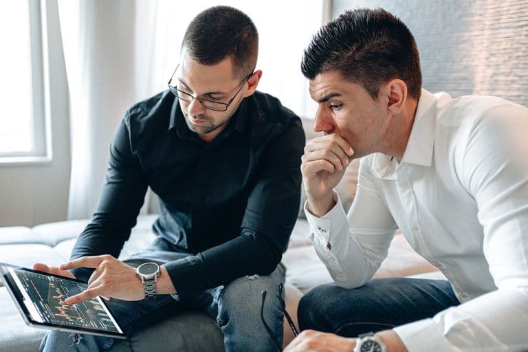 Men reviewing stock info